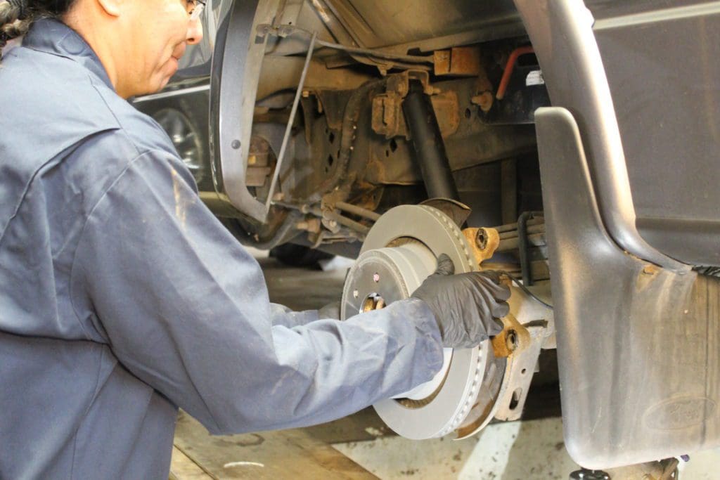 ASE Certified mechanic performing a brake inspection at Royal Wheel Alignment in Rapid City