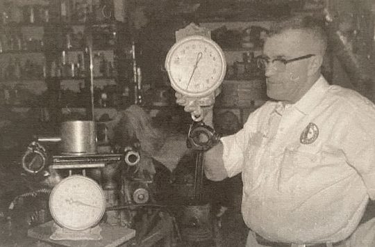 Mechanic weighing a piston Mechanic weighing a piston